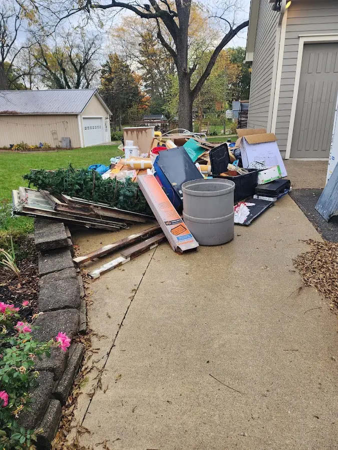 Dumpster being loaded with debris for Roofing Dumpster Rental in Piney Green